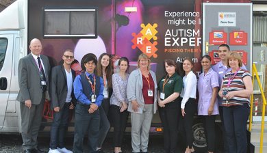 Picture of the WorldSkills Team and competitors in front of the Autism Reality Experience Bus
