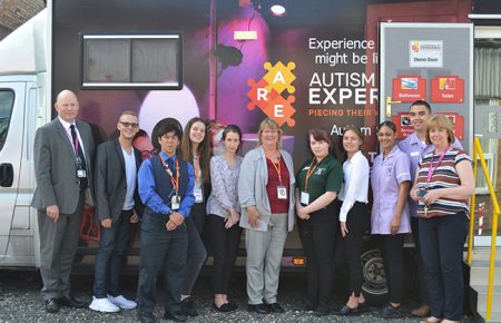 Picture of the WorldSkills Team and competitors in front of the Autism Reality Experience Bus